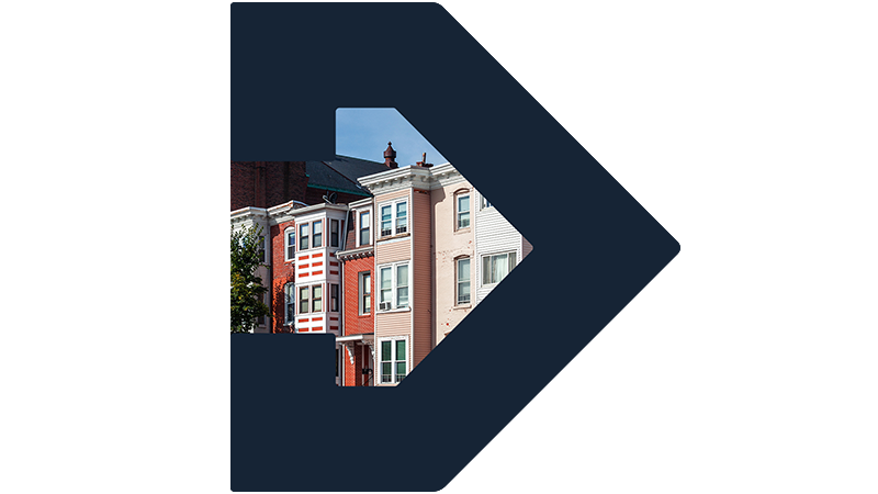 A row of colorful brownstone-style housing