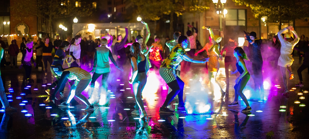 Dancers take part in an evening outdoor dance party 
