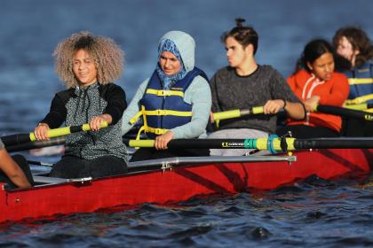 Women rowing in a boat on a river