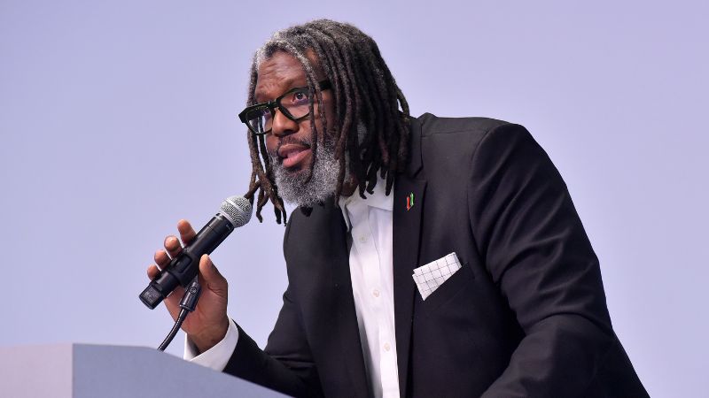 Dwaign Tyndal speaks into a microphone