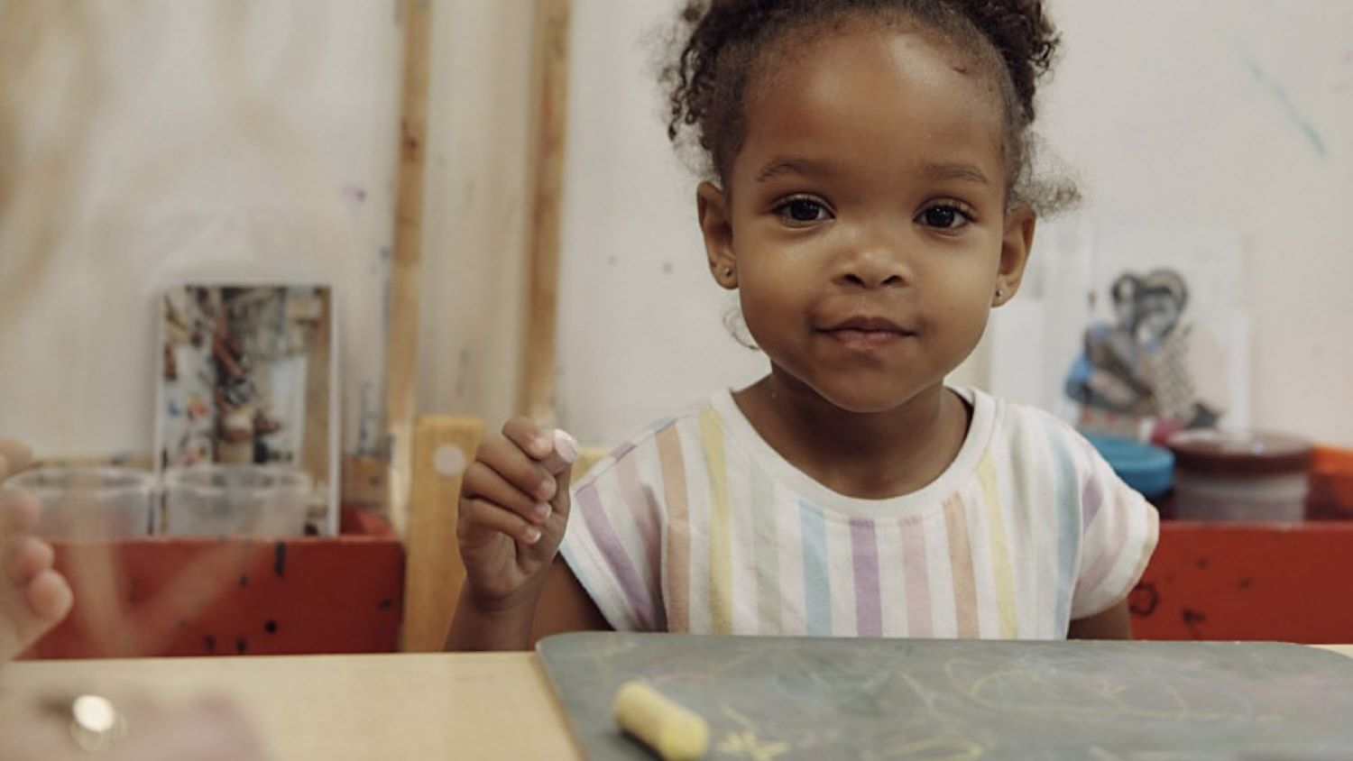 a young girl looks at the camera for a picture
