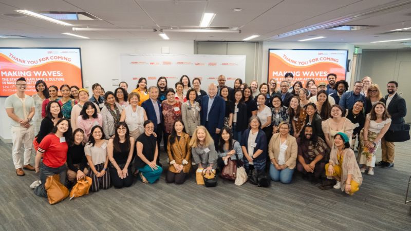 A large group poses for a group photo at the Making Waves report release event in June 2025