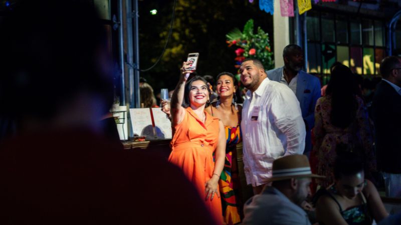 Guests take a selfie at ¡Pa’lante!