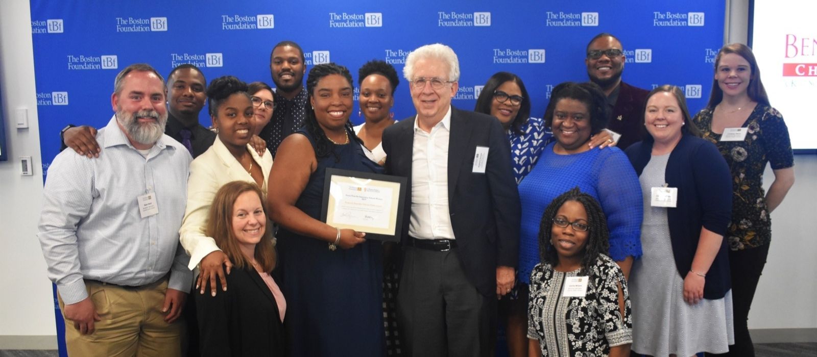 Bob Pozen standing with Banneker School students against a blue and white Boston Foundation backdrop.