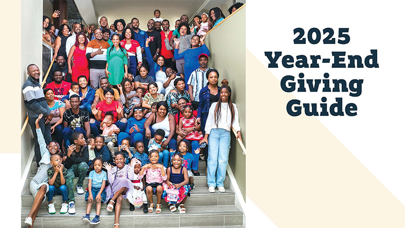 Text: 2025 Year-End Giving Guide. Photo of a large group of people gathered on a staircase posing for a photo