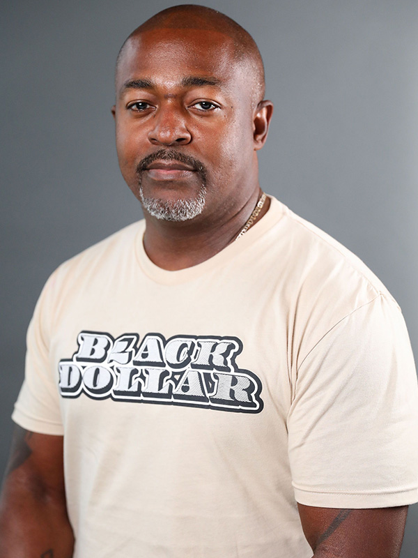 Headshot photo of Daniel Laurent, a black man. He is bald with a goatee.
