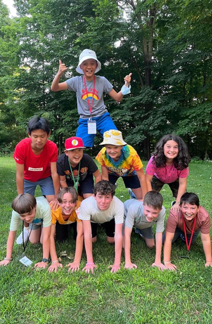 Campers form a human pyramid