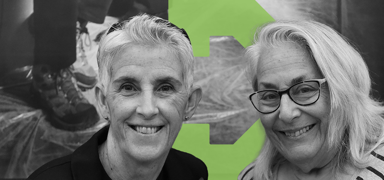 Two older women sit smiling for a close up photo. Edited into the background of the photo is the green TBF arrow icon