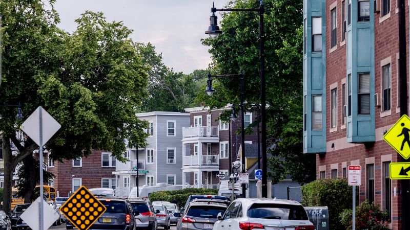 Photo looking down a Boston street with multiple types of buildings and cars lining the street