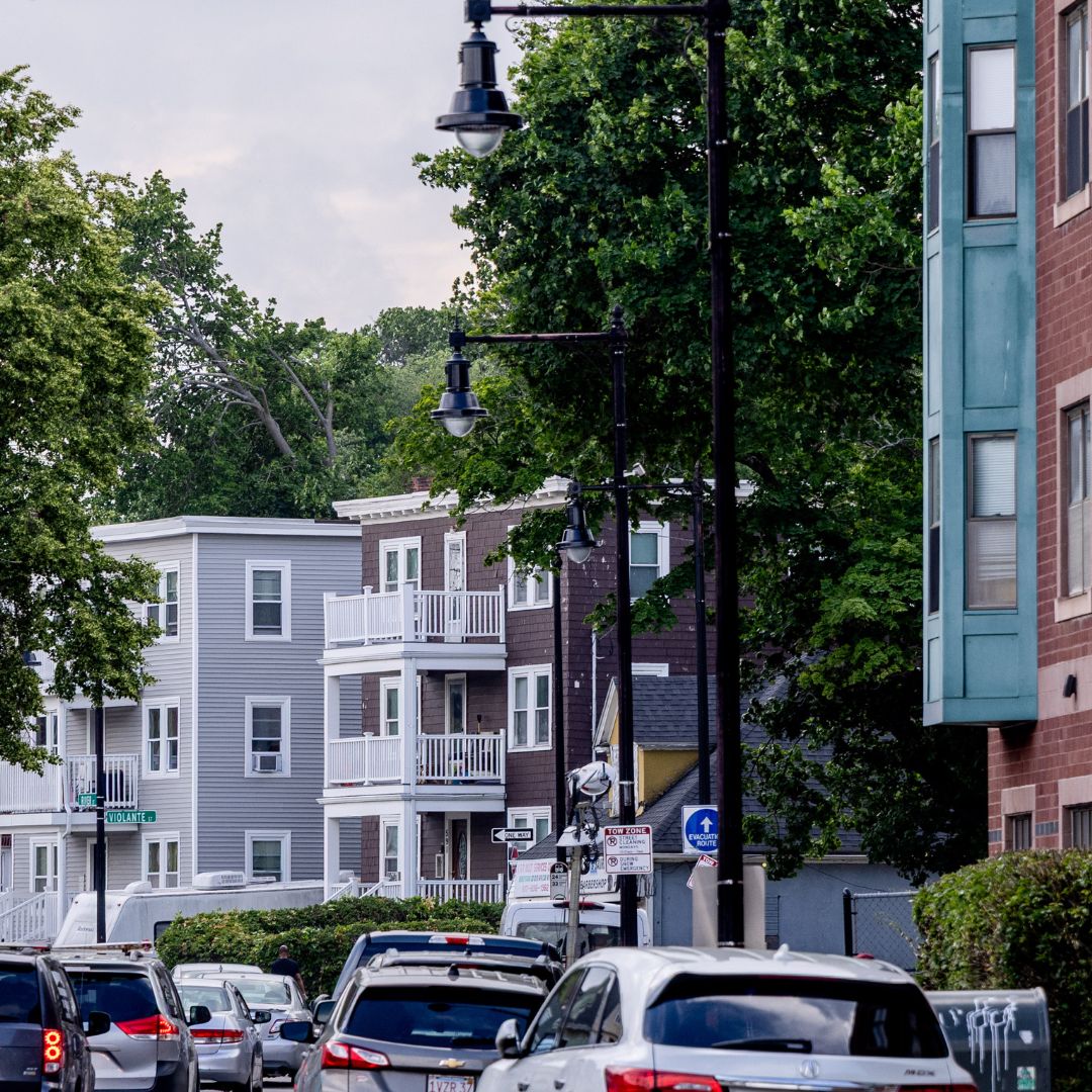 Photo looking down a Boston street with multiple types of buildings and cars lining the street