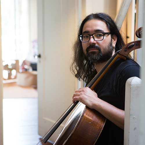 Leo Eguchi sits with a cello