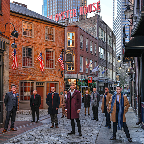 Renaissance Men, a group of men, stand in the street in Boston