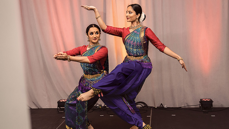 Two women perform a dance onstage