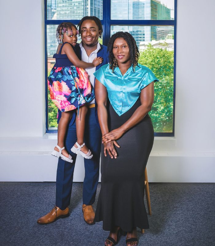 Black Refugee and Immigrant Community Coalition family portrait session photo of a family with a mom, dad, and young girl