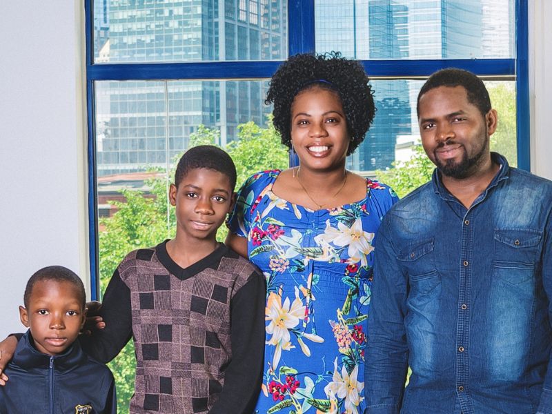 Black Refugee and Immigrant Community Coalition family portrait session photo of a family with two boys, mom, and dad.