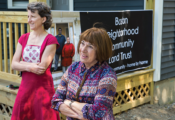 Meridith Levy and Anne Bromer stand outside a house