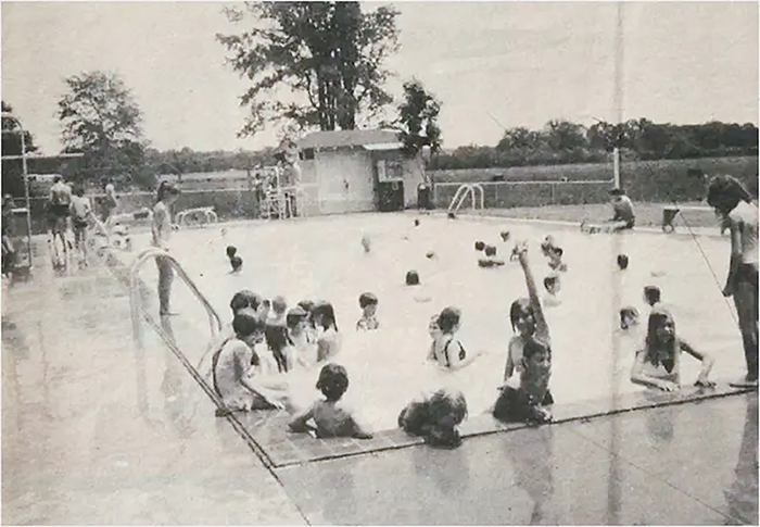 A black and white photo from 1969 of a public swimming pool in Stonewall, Mississippi being used only by white children