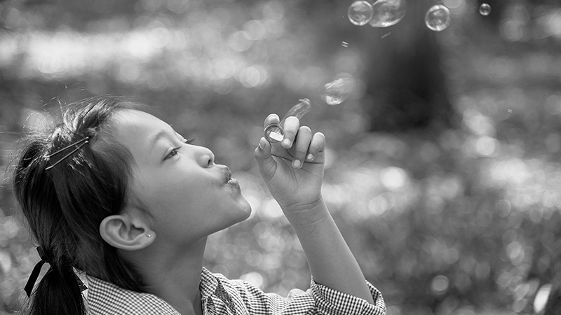 Asian girl blowing bubbles