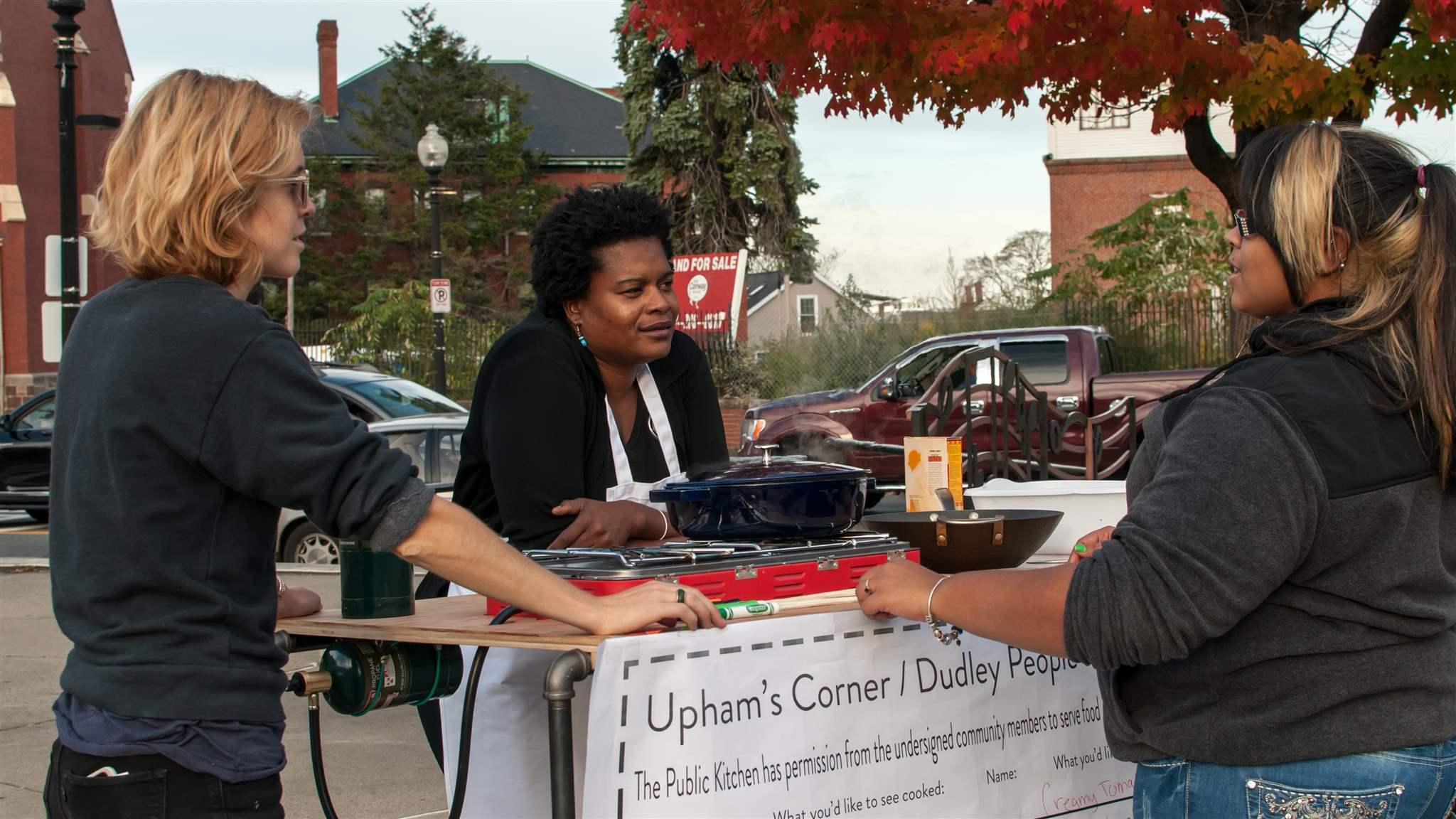 three women at Upham's Corner booth