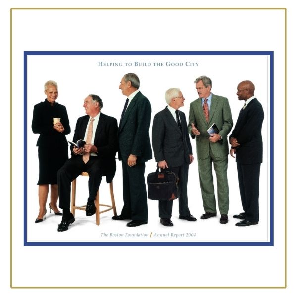 TBF board members wearing dark colored professional attire, standing on a white floor and background. They are standing in a row, smiling and talking to each other. Slate blue text at the top reads "Helping to Build the Good City."  Text of the same color at the bottom reads "The Boston Foundation|Annual Report 2004."