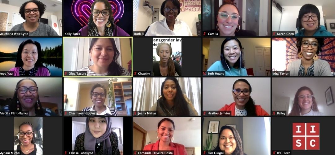 A racially diverse group of women on a Zoom screen, each with their own box. They're all smiling. 