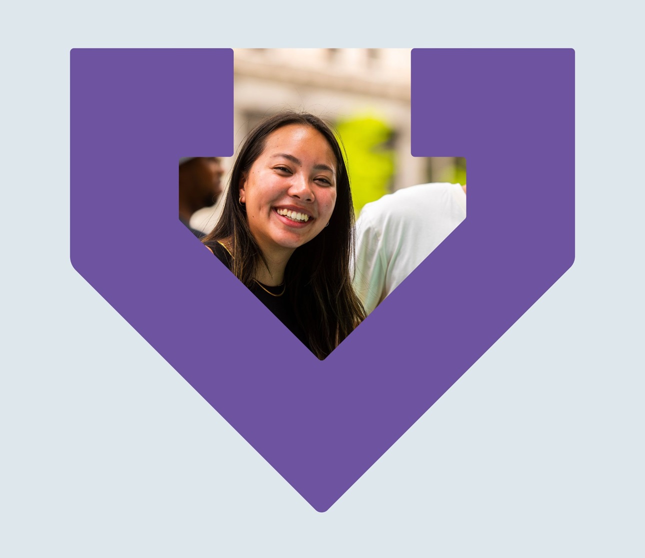 A woman smiling is framed by the purple TBF logo arrow