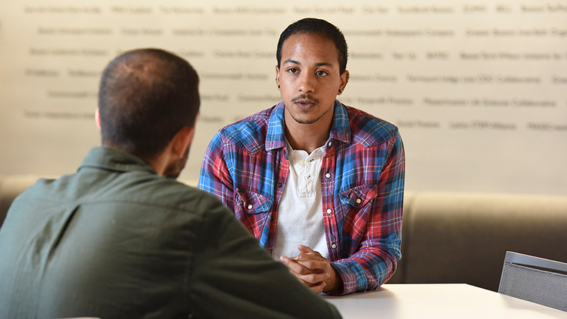 A young man in conversation at the TBF office