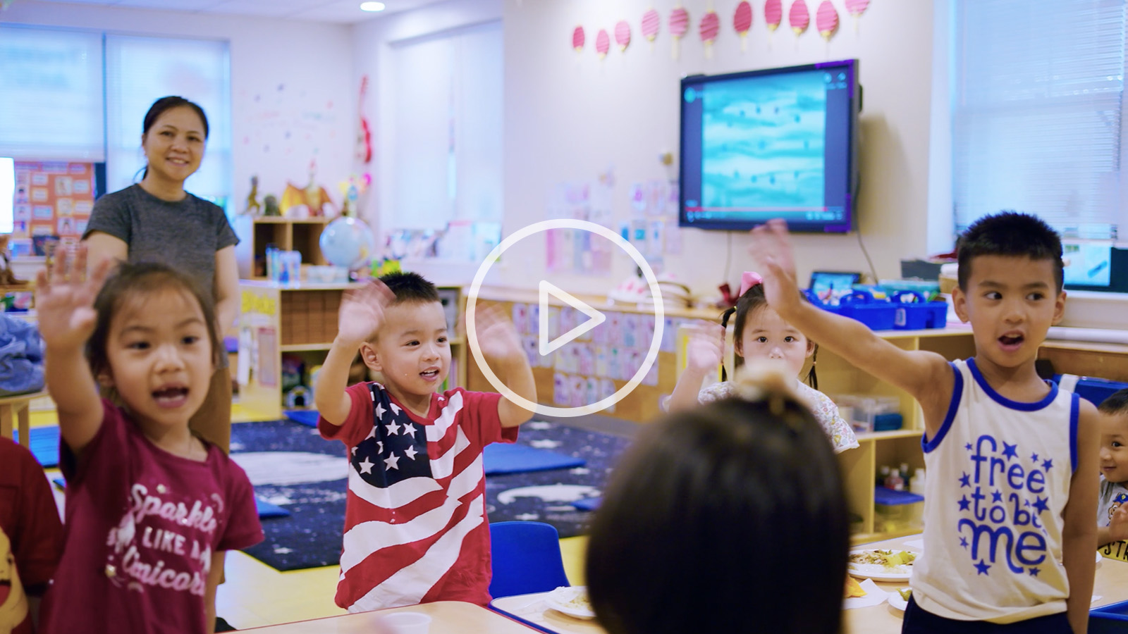 children waving at camera with play button Safety Net Grants